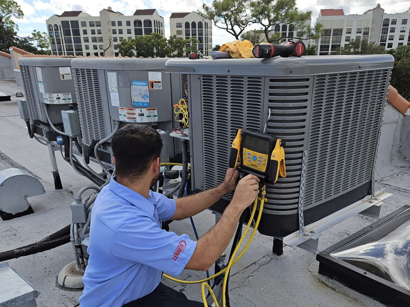 Air Squad technician testing air conditioner unit on roof