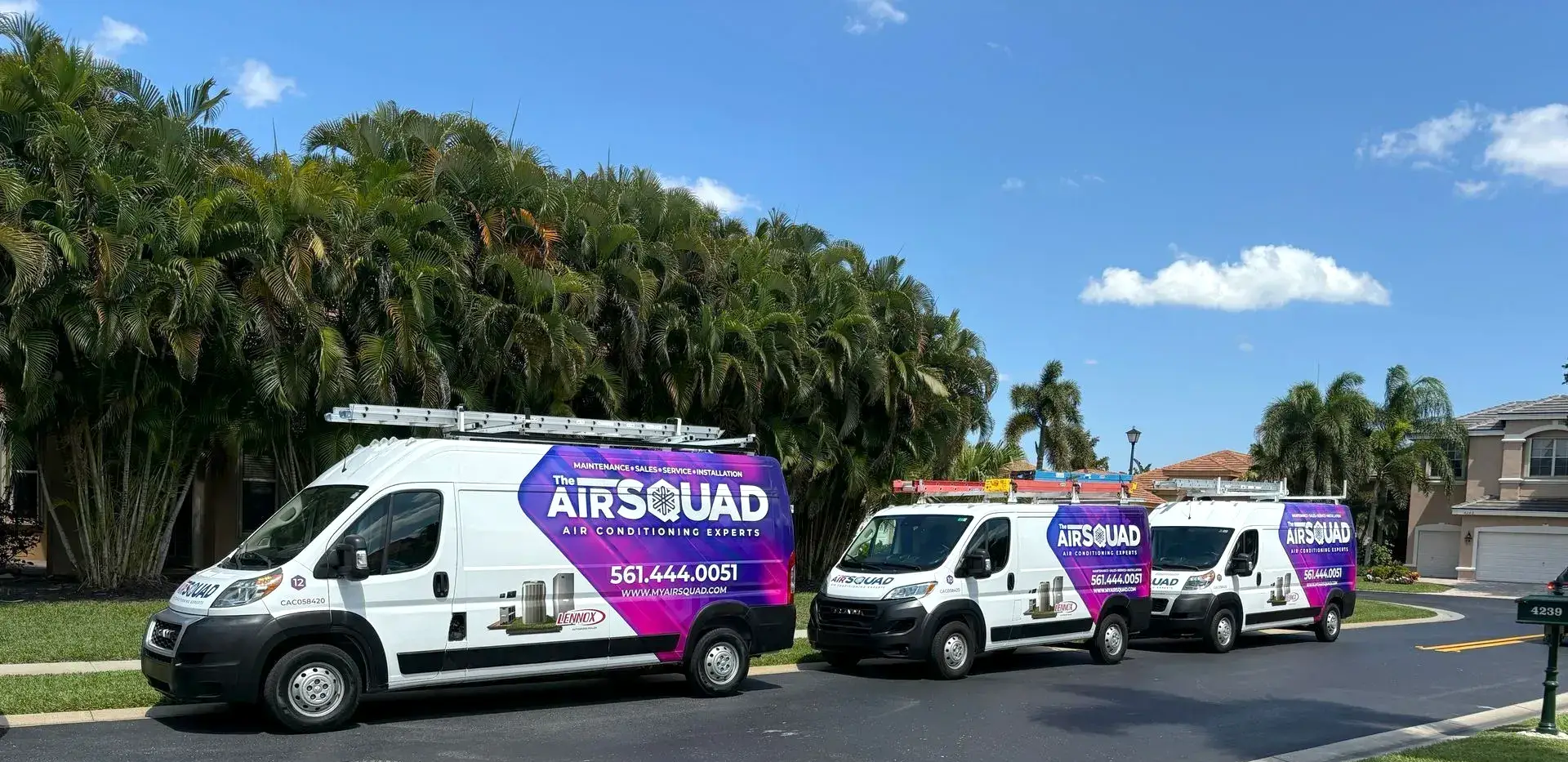 Air Squad vans parked on neighborhood street